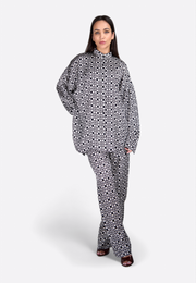 Model wearing black and white geometric printed shirt, front view, East Vibe